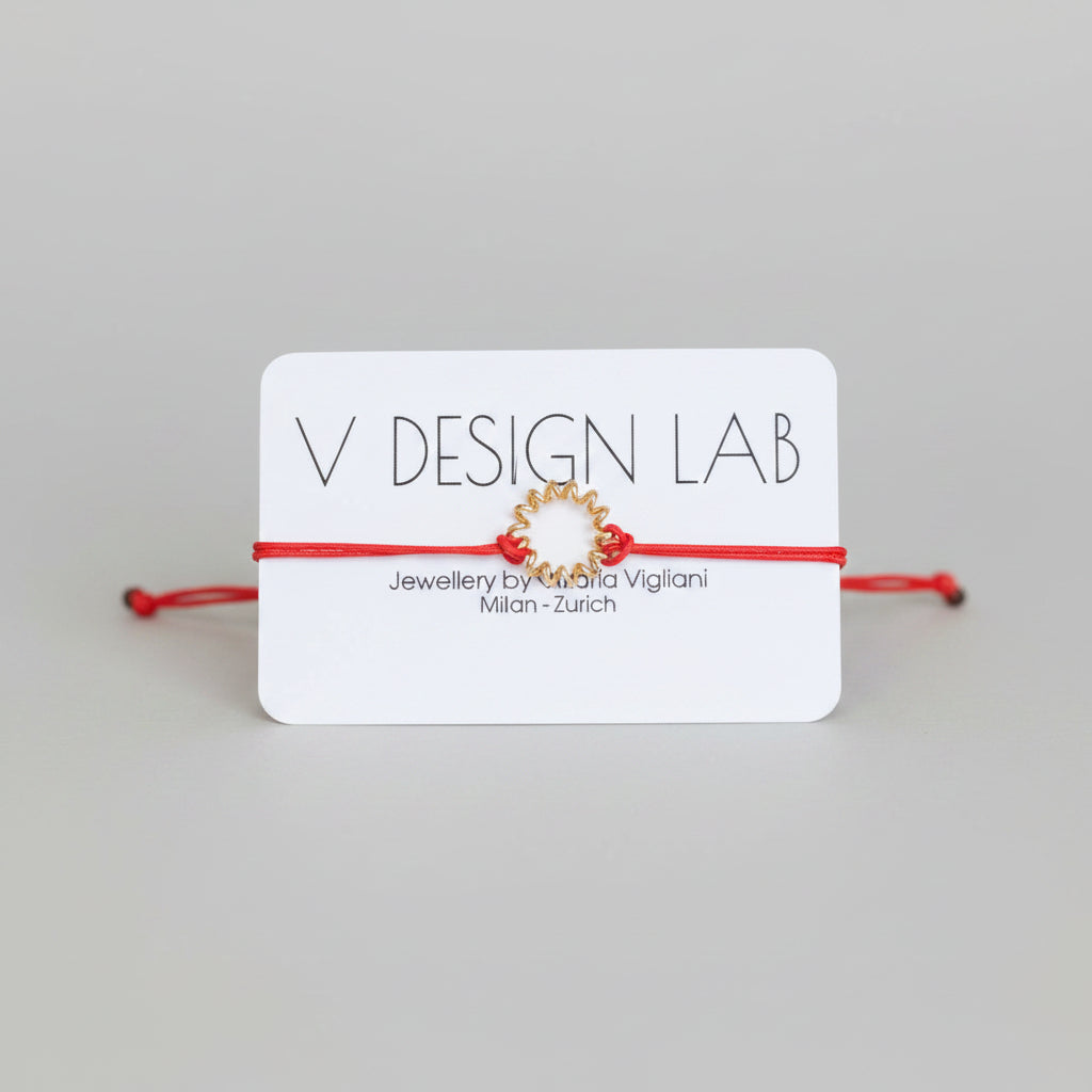 Coral Red bracelet with Spira Molla circular design on a 'V Design Lab' card