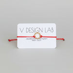 Coral Red bracelet with Spira Molla circular design on a 'V Design Lab' card