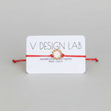 Coral Red bracelet with Spira Molla circular design on a 'V Design Lab' card
