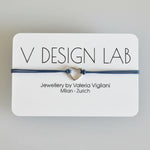 Bracelet with heart charm on a V Design Lab card 